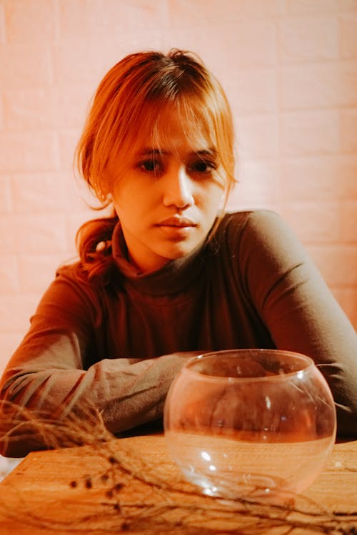 Free Glass Bowl in front of a Woman Wearing a Gray Long Sleeve Shirt Stock Photo
