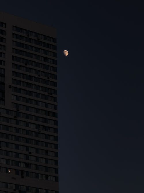 Free Moon over High Rise Building Stock Photo