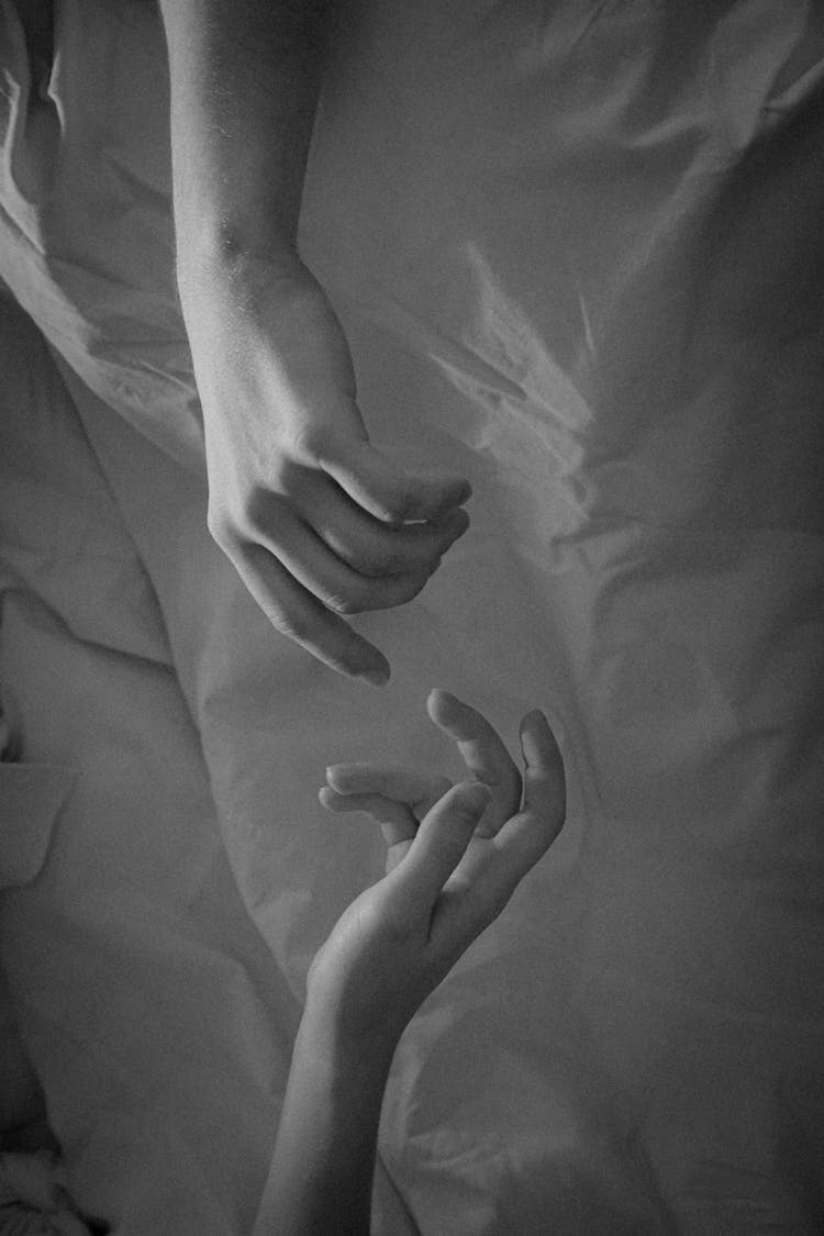 Close-up Of Couple Hands Reaching For Touching