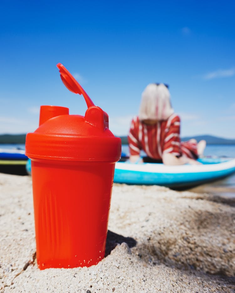 Plastic Water Bottle In Sand On Beach