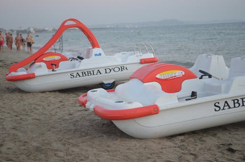 White and Red Boats on Beach