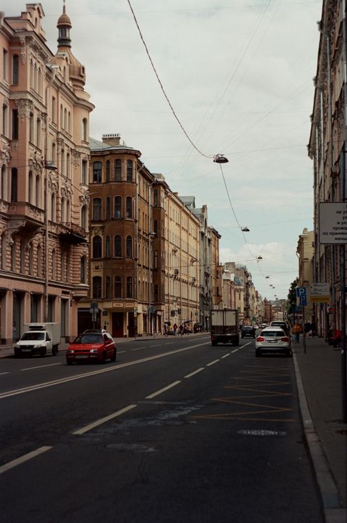 Free Wide-angle view of historic architecture and vehicles on a city street in St Petersburg. Stock Photo