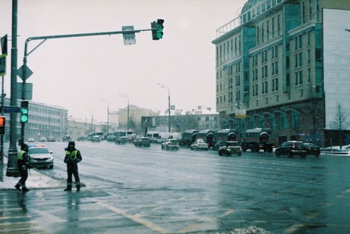 Free City street view with police officers and cars on a snowy day. Stock Photo