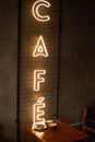 Neon Light Signage Near a Wooden Table