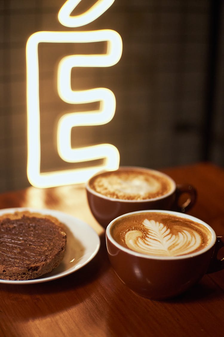 Cups Of Coffee And Chocolate Brownie On Saucer