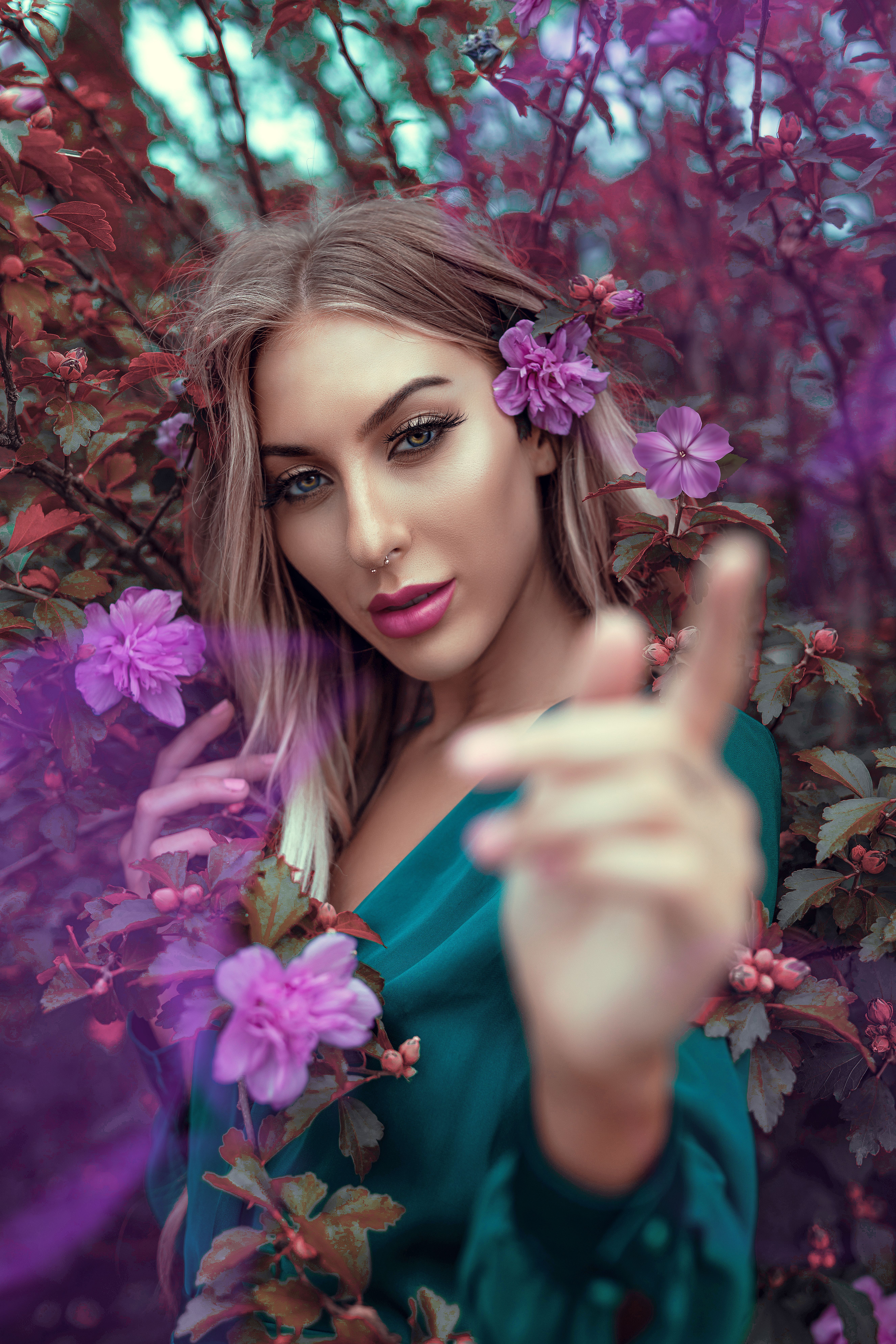 A captivating portrait of a young woman in a floral setting exuding vibrant elegance.