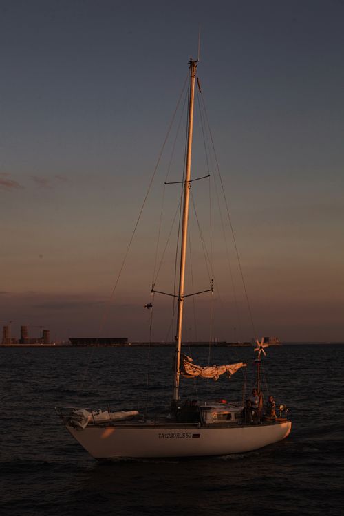 Free A serene yacht sailing at sunset in St. Petersburg harbor, perfect for travel and leisure imagery. Stock Photo