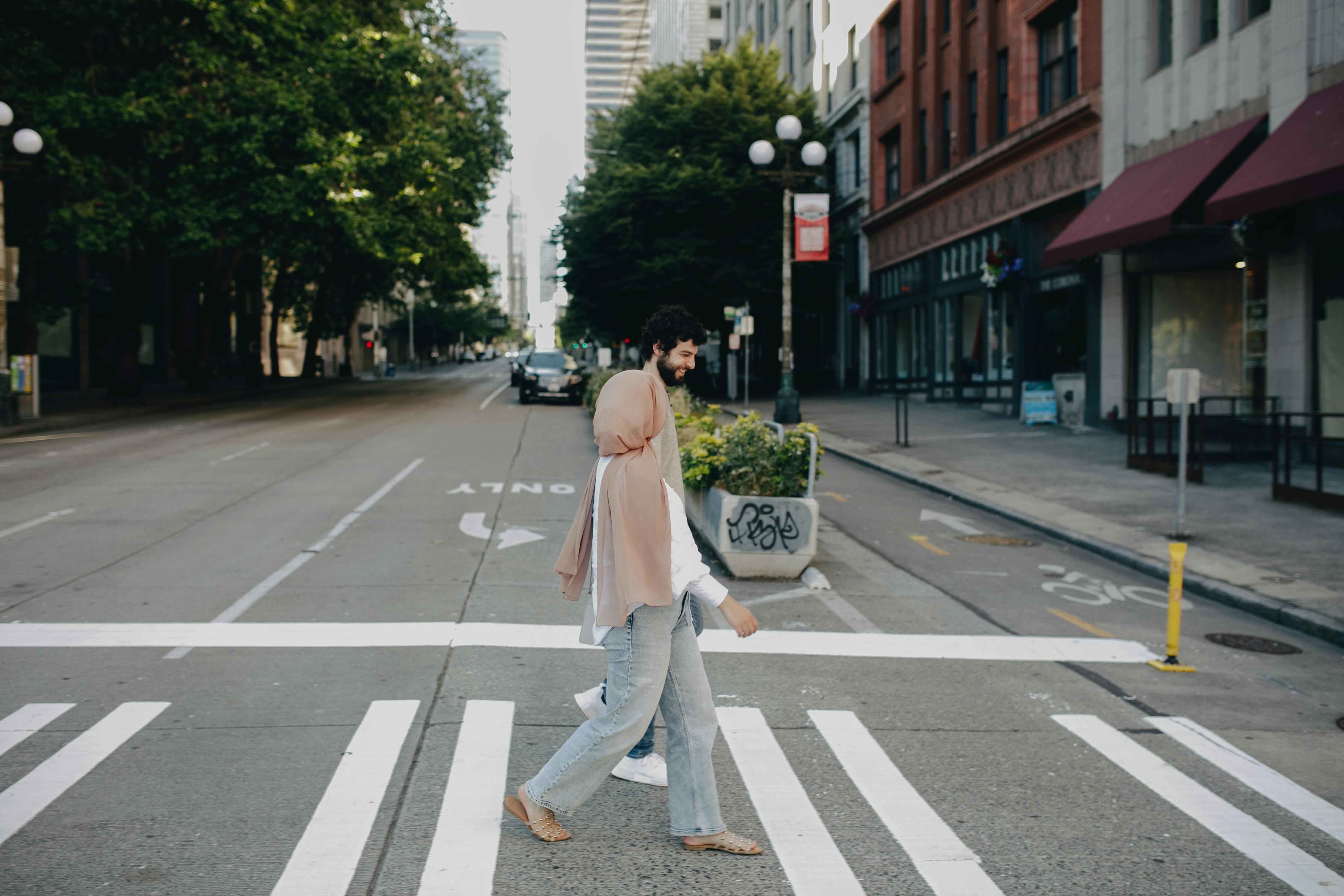 Man In Jeans Walking Across A Zebra Crossing Stock Photo - Download Image  Now - Crosswalk, Zebra Crossing, Crossing - iStock