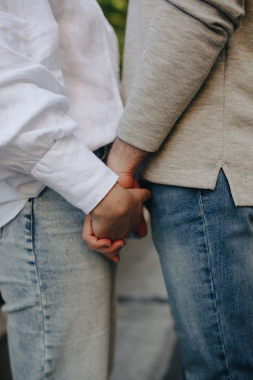 Free A close-up shot of a couple holding hands, symbolizing love and connection. Stock Photo