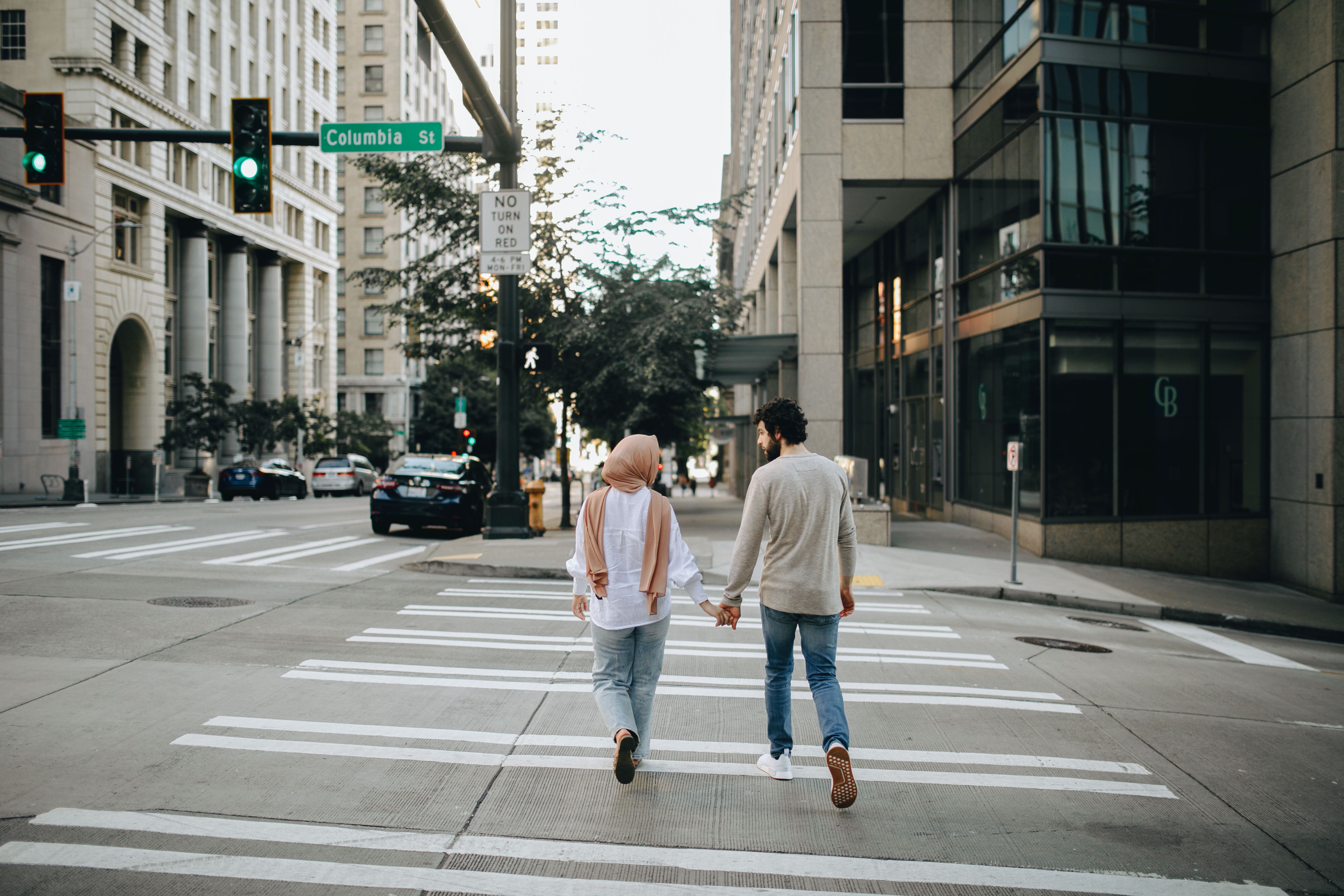 Seattle couple crossing the street holding hands - Seattle WA relationship autopilot