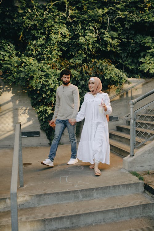 Free A Couple Walking on the Stairs Stock Photo
