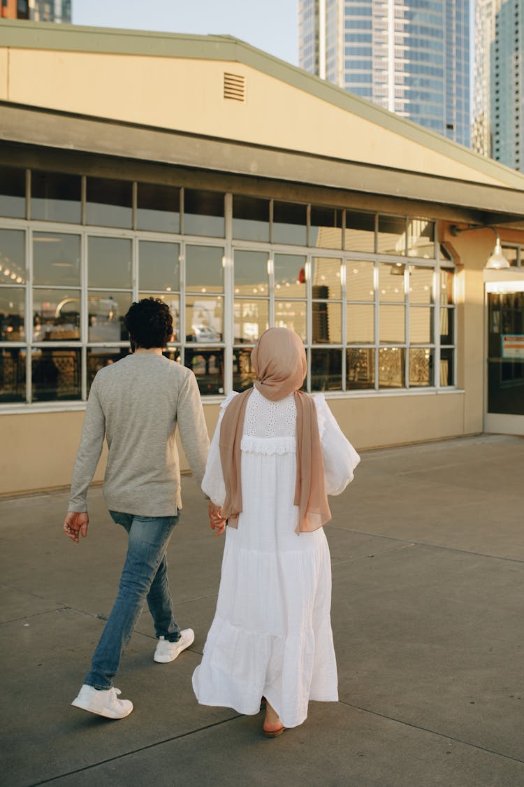 A Couple Walking Outside Of The Restaurant