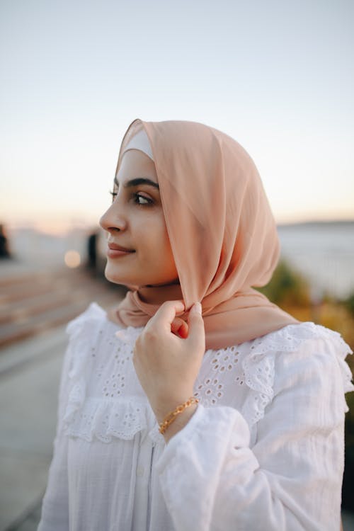 Woman in Beige Hijab and White Dress