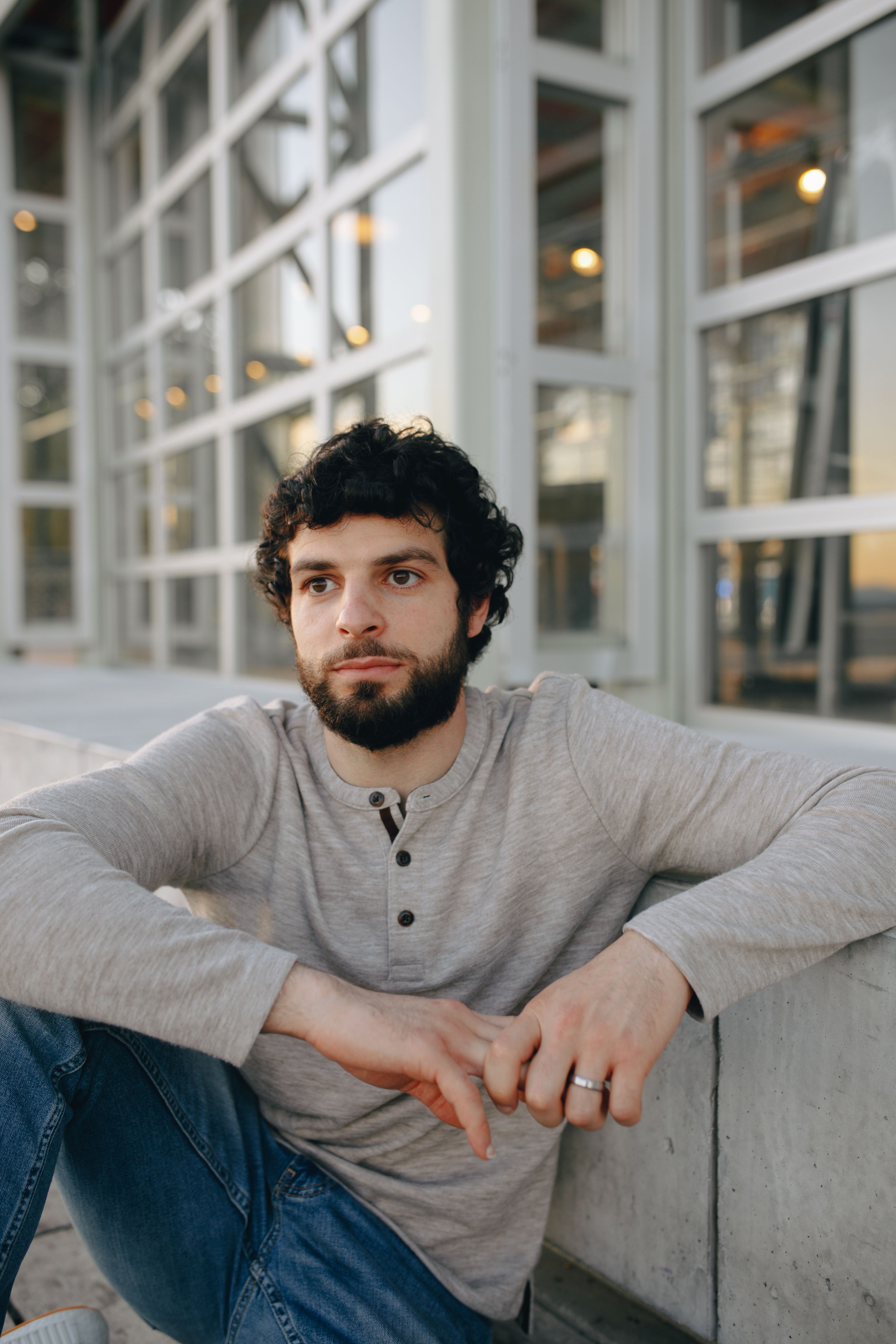 A Bearded Man in Gray Sweater and Denim Jeans · Free Stock Photo
