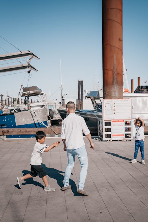 Free Kids Playing Together with Their Dad Stock Photo