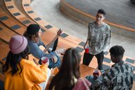 Boy in Gray Sweater Playing Guitar