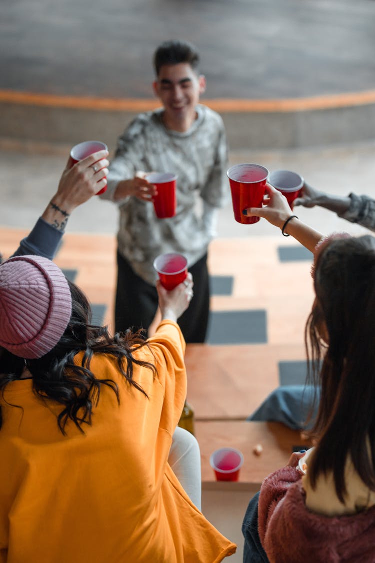 Group Of Friends Toasting Their Plastic Cups