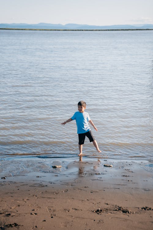 A Boy Walking at the Beach