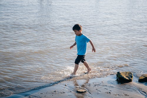 A Boy Running at the Beach