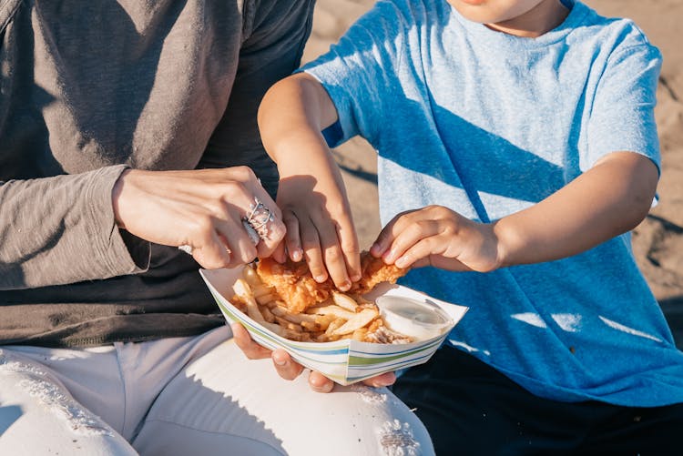 Parent And A Child Sharing Food