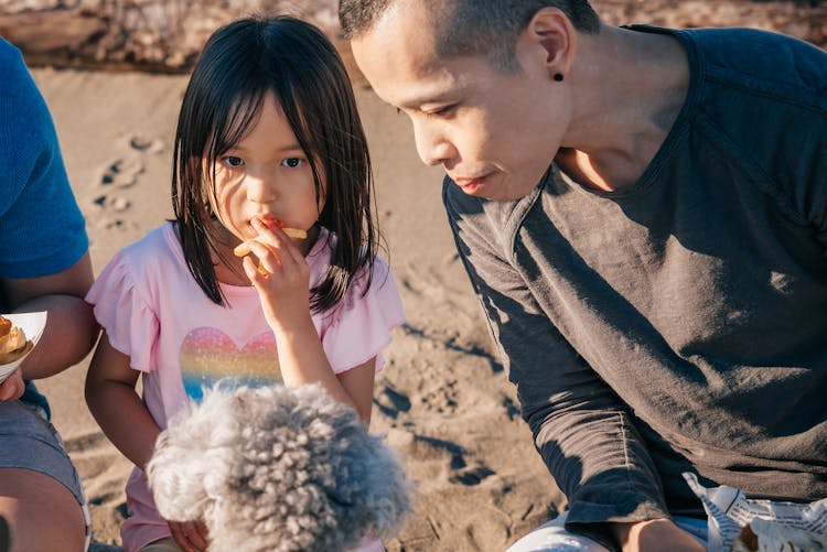 Dad And Daughter Eating A Snack