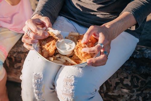 Close-Up Photo of a Person Eating a Snack