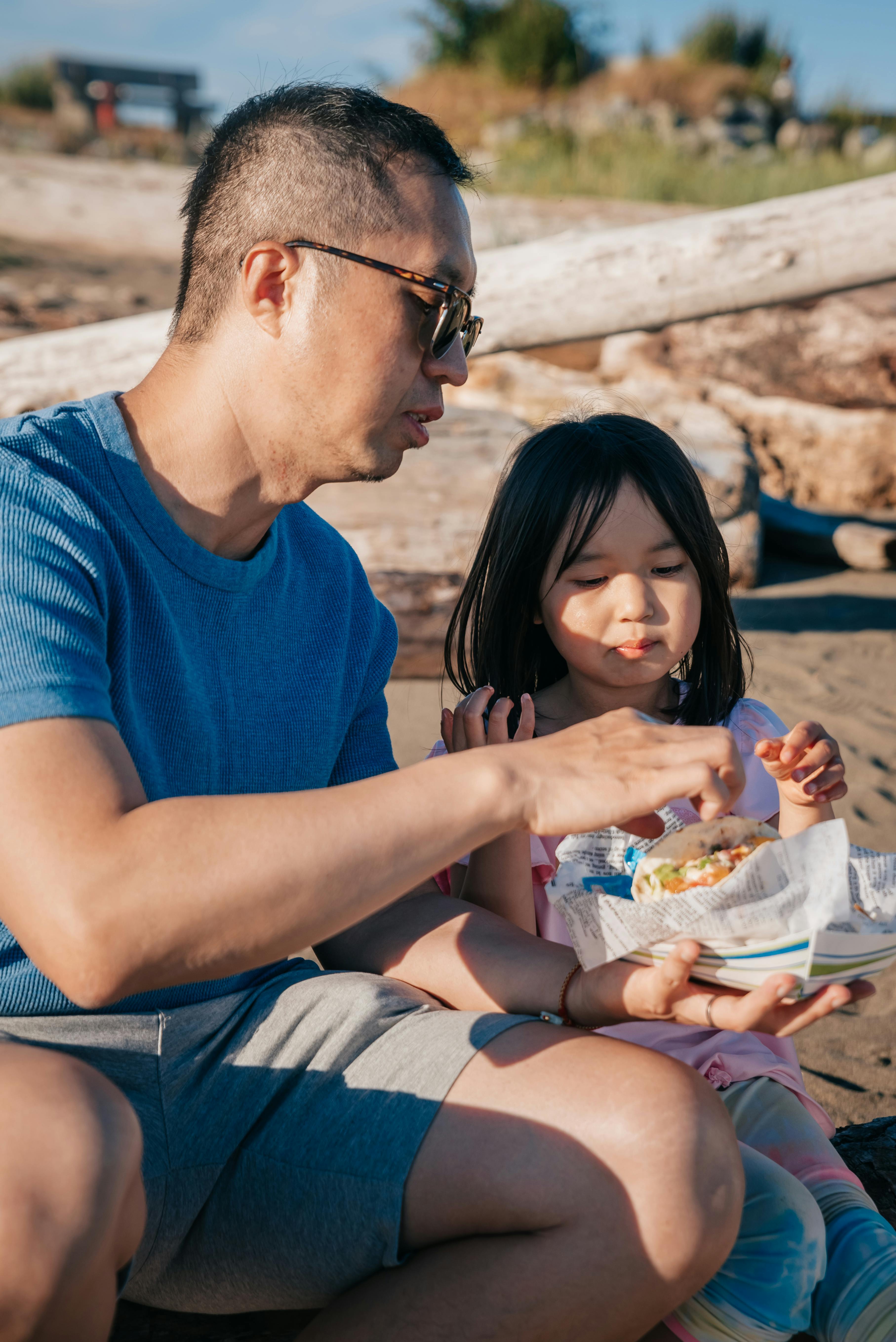 Dad and Daughter Eating a Snack · Free Stock Photo