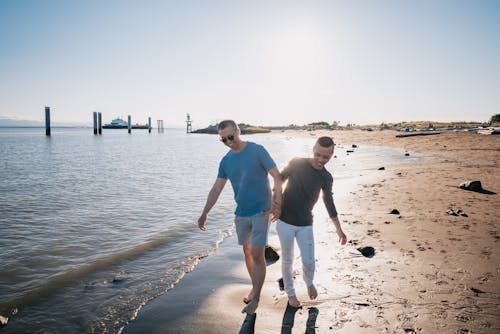 Men Walking Alongside the Sea