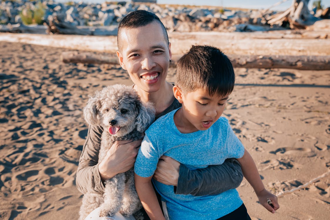 Free Father Carrying His Son and Pet Dog Stock Photo