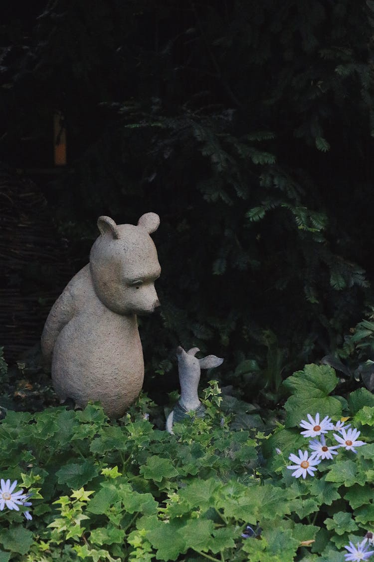 Figurine Of Winnie The Pooh And Piglet Near Green Plants