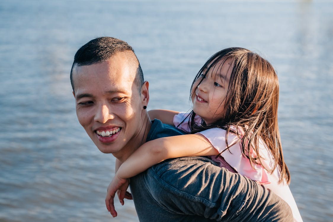 Free Dad Carrying His Cute Daughter Stock Photo