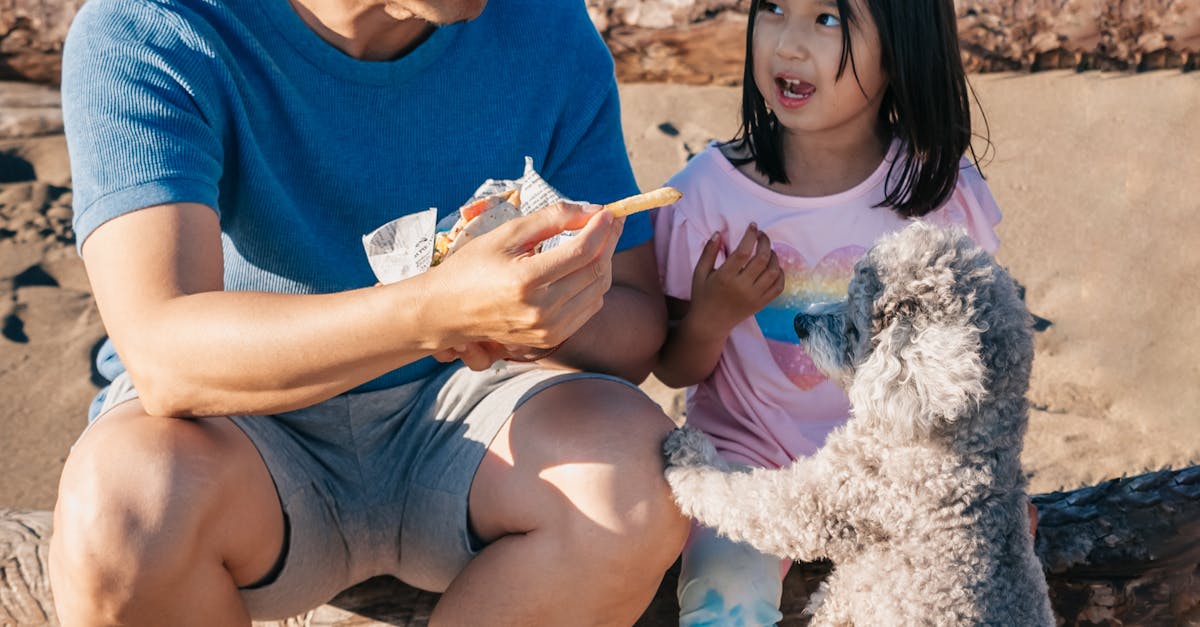 Dad and Daughter Feeding Their Dog