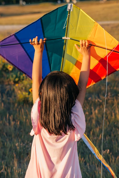 Back View of Girl Holding a Colorful Kite