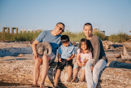 Happy Family Sitting on a Log