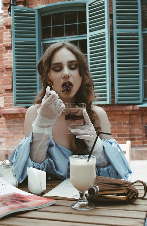 A Woman with Curly Hair Eating Ice Cream