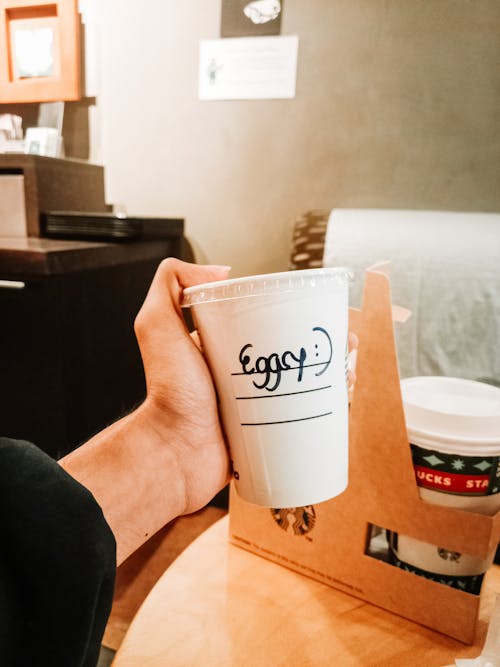 Person Holding a Disposable Cup