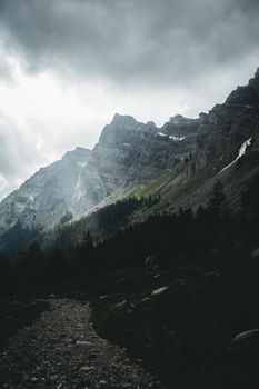 Moody mountain landscape in Gryon, Switzerland with gray clouds and rocky peaks.