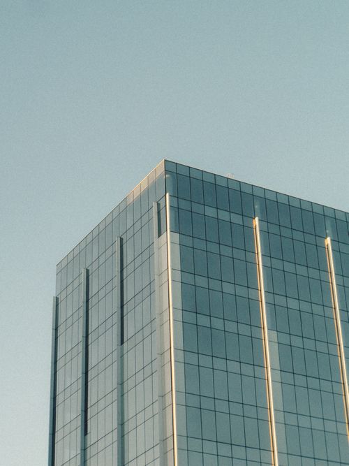Free A contemporary skyscraper with glass facade reflecting the blue sky in Rio de Janeiro. Stock Photo