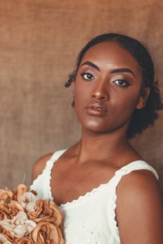 Beautiful portrait of a young woman with a bouquet, showcasing elegance and grace.