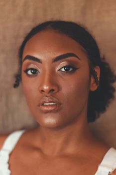 Stunning close-up portrait of a woman with afro hair, highlighting her natural beauty.
