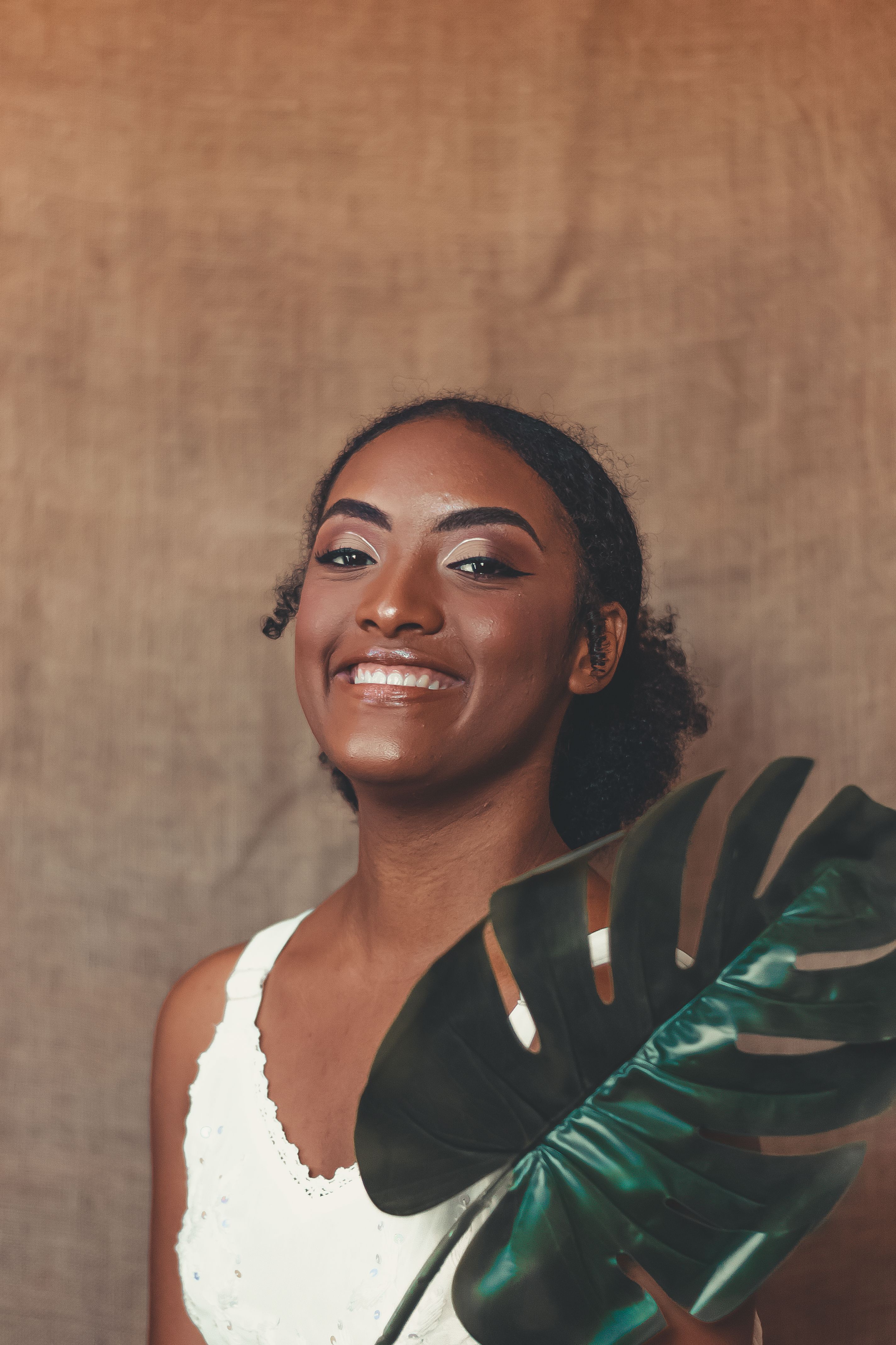 Woman Holding a Leaf While Smiling · Free Stock Photo