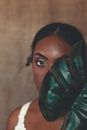 Woman in White Shirt Wearing Green Leather Mask