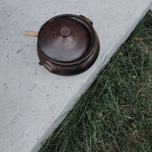 Free Brown Round Clay Pot on Concrete Ground Stock Photo