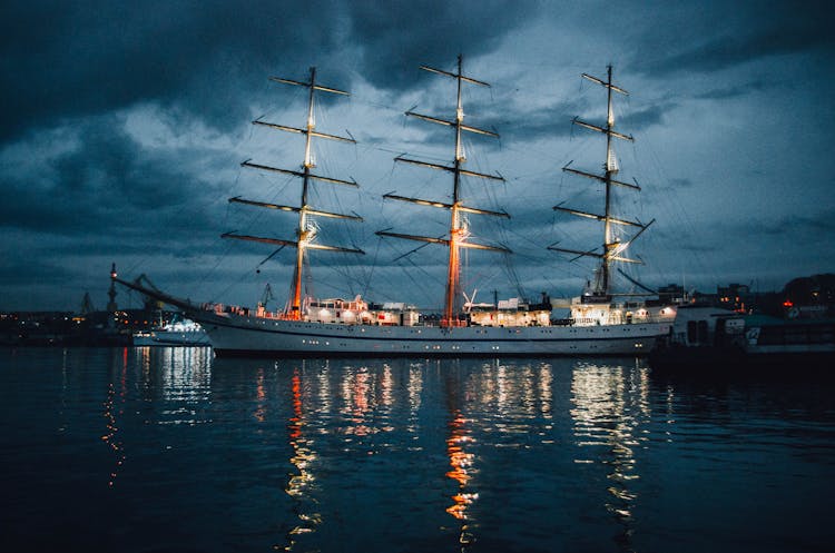 A Ship Docked On The Port At Night