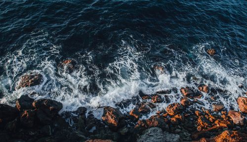 Free Aerial view of rocky shoreline with foamy ocean waves in Sevastopol, a stunning coastal scenery. Stock Photo