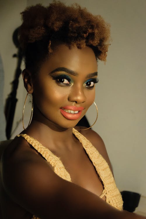 Free A Young Woman Posing with Large Hoop Earrings Stock Photo