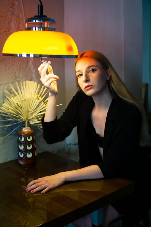 Woman in Black Blazer Sitting at a Table