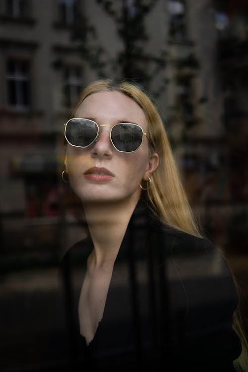 Portrait of a Blond Woman in a Black Dress and Sunglasses