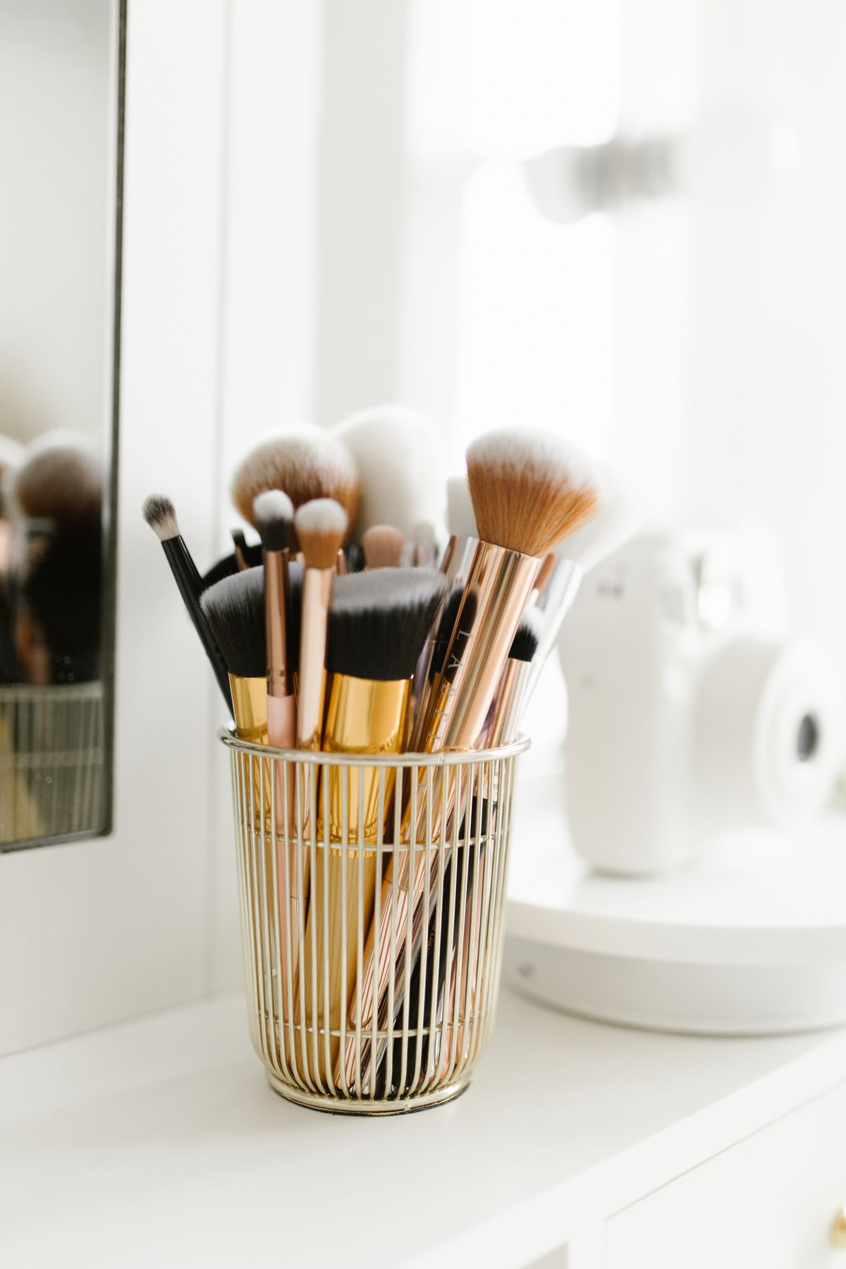 Makeup brushes arranged in an elegant vanity setting