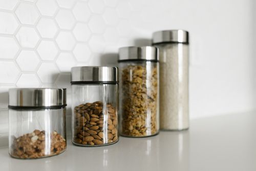 Free Stylish glass jars filled with food for a modern kitchen organization. Stock Photo